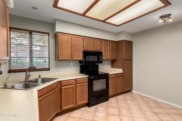 9002 W Caribbean Ln, Peoria, AZ 85381 - kitchen with black appliances, a sink, brown cabinetry, light countertops, and light tile patterned floors