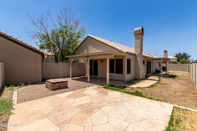 9002 W Caribbean Ln, Peoria, AZ 85381 - back of property featuring stucco siding, a patio, a fenced backyard, a tile roof, and a fire pit