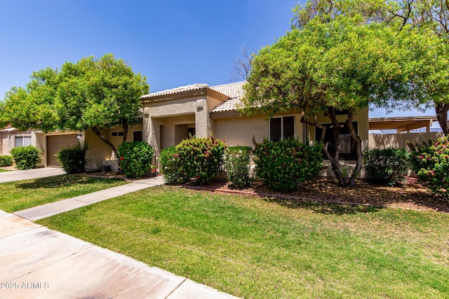 9002 W Caribbean Ln, Peoria, AZ 85381 - view of front facade with an attached garage, stucco siding, concrete driveway, a front yard, and a tiled roof