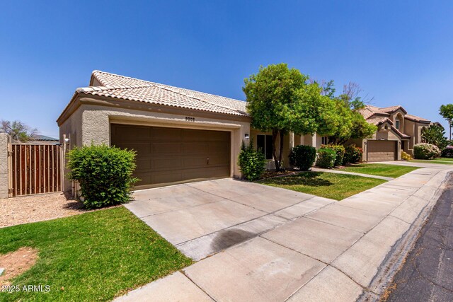 9002 W Caribbean Ln, Peoria, AZ 85381 - view of front of house featuring stucco siding, a tile roof, driveway, and an attached garage