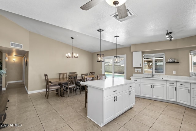 6605 W Altadena Ave, Glendale, AZ 85304 - kitchen with light countertops, ceiling fan, light tile patterned floors, plenty of natural light, and lofted ceiling