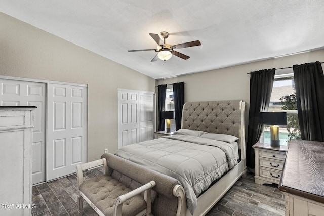 6605 W Altadena Ave, Glendale, AZ 85304 - bedroom with vaulted ceiling, dark wood-style flooring, multiple closets, and ceiling fan