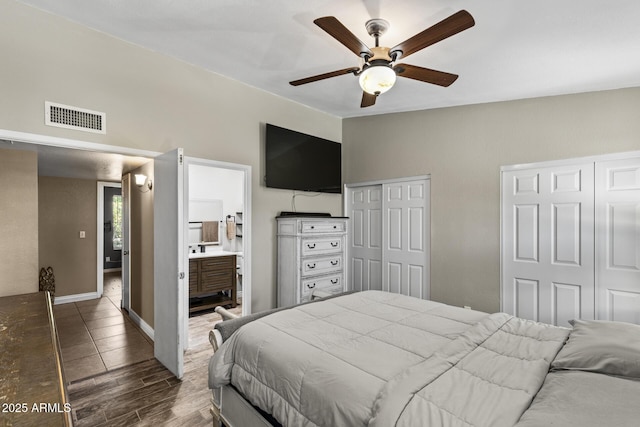 6605 W Altadena Ave, Glendale, AZ 85304 - bedroom with multiple closets, dark wood-style flooring, ensuite bathroom, and ceiling fan