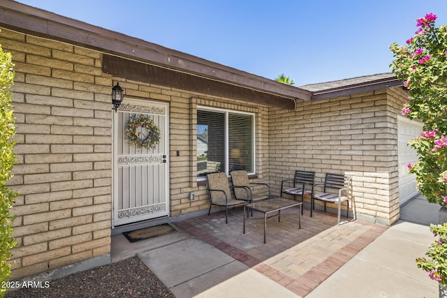 6605 W Altadena Ave, Glendale, AZ 85304 - view of exterior entry featuring brick siding and an attached garage