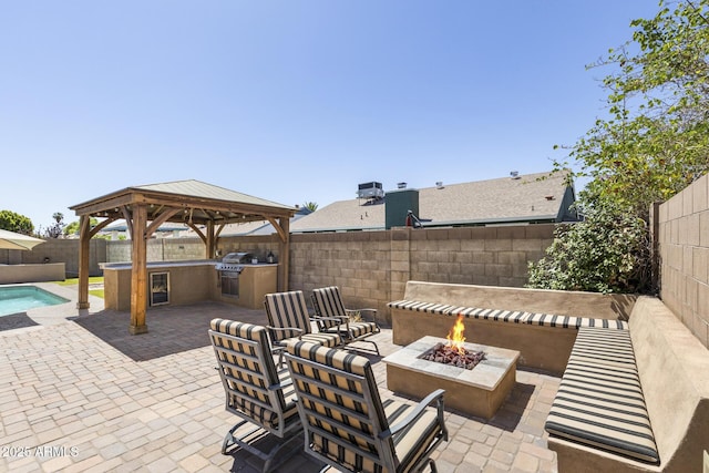 6605 W Altadena Ave, Glendale, AZ 85304 - fenced backyard featuring an outdoor fire pit, a gazebo, a patio, and exterior kitchen