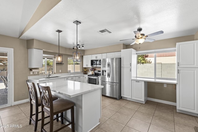 6605 W Altadena Ave, Glendale, AZ 85304 - kitchen featuring stainless steel appliances, white cabinetry, light tile patterned flooring, a ceiling fan, and plenty of natural light