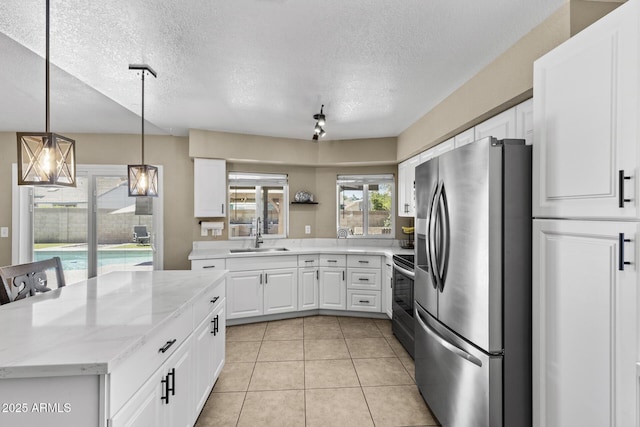 6605 W Altadena Ave, Glendale, AZ 85304 - kitchen featuring stainless steel appliances, white cabinetry, hanging light fixtures, a textured ceiling, and light stone countertops