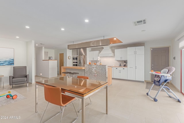 dining area with light tile patterned floors and sink