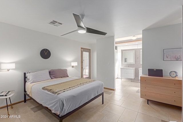 tiled bedroom with ceiling fan and connected bathroom