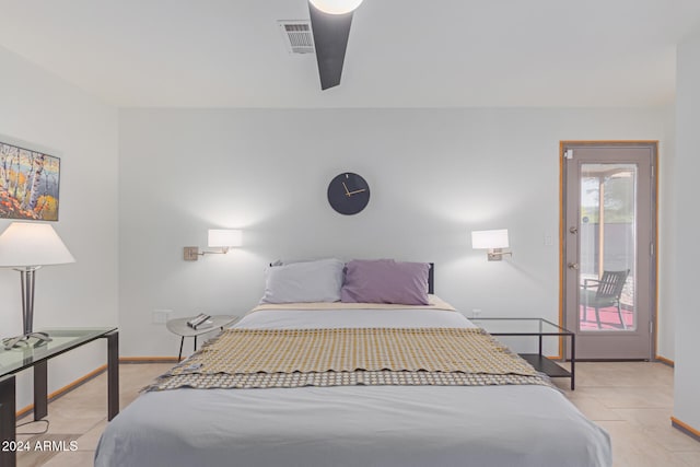 tiled bedroom featuring ceiling fan