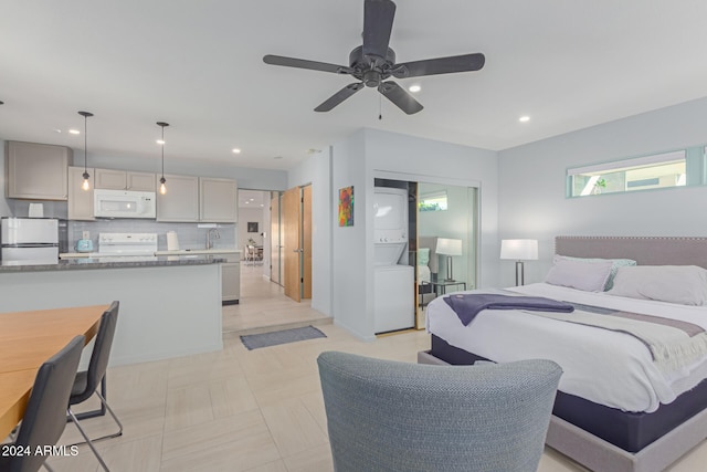 bedroom featuring ceiling fan, white refrigerator, and sink