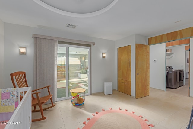 interior space with washer and dryer and light tile patterned flooring