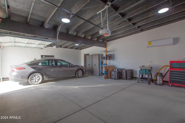 garage with a garage door opener and a wall unit AC