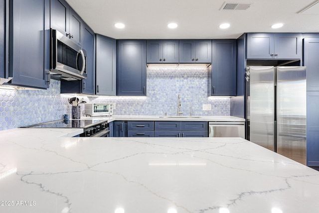 15225 N 100th St Unit 1185, Scottsdale, AZ 85260 - kitchen featuring stainless steel appliances, light stone countertops, and backsplash