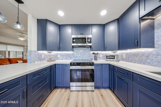 15225 N 100th St Unit 1185, Scottsdale, AZ 85260 - kitchen featuring appliances with stainless steel finishes, blue cabinets, light stone countertops, backsplash, and recessed lighting