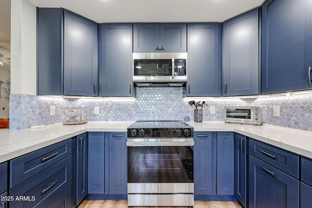 15225 N 100th St Unit 1185, Scottsdale, AZ 85260 - kitchen featuring appliances with stainless steel finishes, blue cabinets, and light stone counters