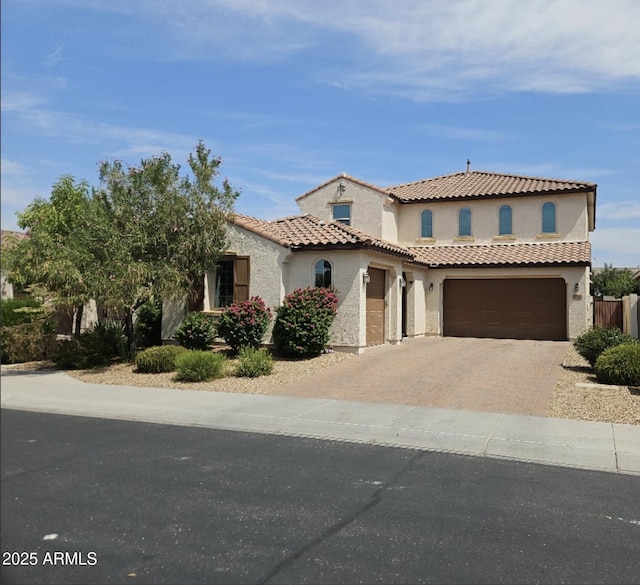 3796 E Rakestraw Ln, Gilbert, AZ 85298 - mediterranean / spanish-style house with stucco siding, decorative driveway, a tiled roof, and an attached garage