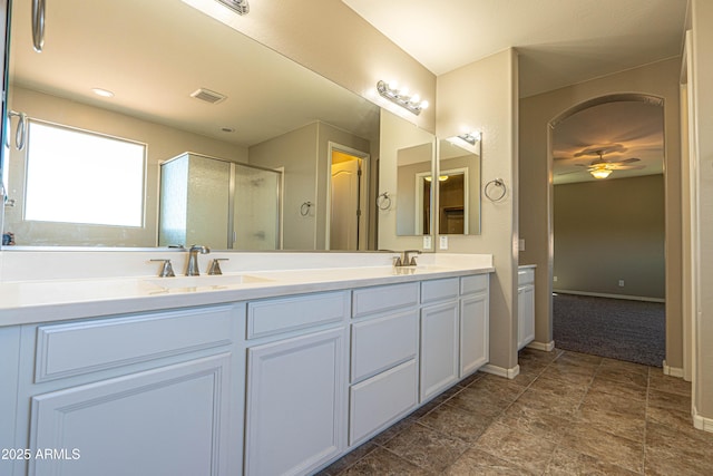 3796 E Rakestraw Ln, Gilbert, AZ 85298 - bathroom with a stall shower, ceiling fan, baseboards, and double vanity