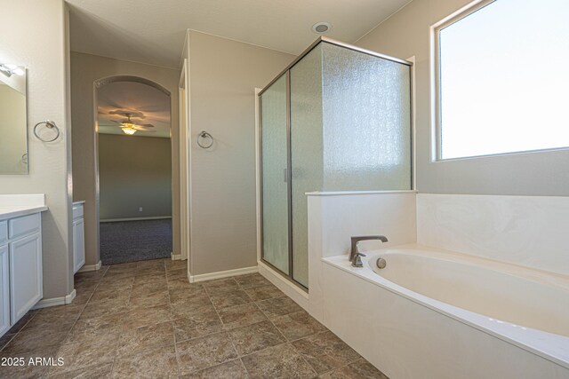 3796 E Rakestraw Ln, Gilbert, AZ 85298 - bathroom featuring vanity, a shower stall, a bath, a ceiling fan, and stone finish floors