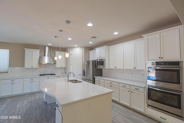 3796 E Rakestraw Ln, Gilbert, AZ 85298 - kitchen with appliances with stainless steel finishes, wall chimney range hood, a sink, decorative backsplash, and recessed lighting