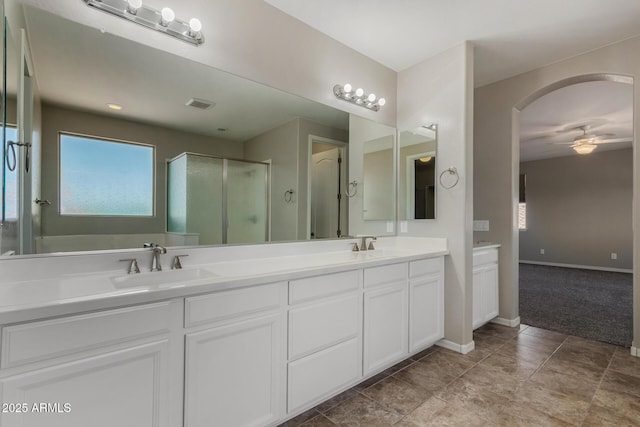 3796 E Rakestraw Ln, Gilbert, AZ 85298 - bathroom with a ceiling fan, a stall shower, double vanity, and baseboards