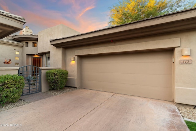 view of garage at dusk