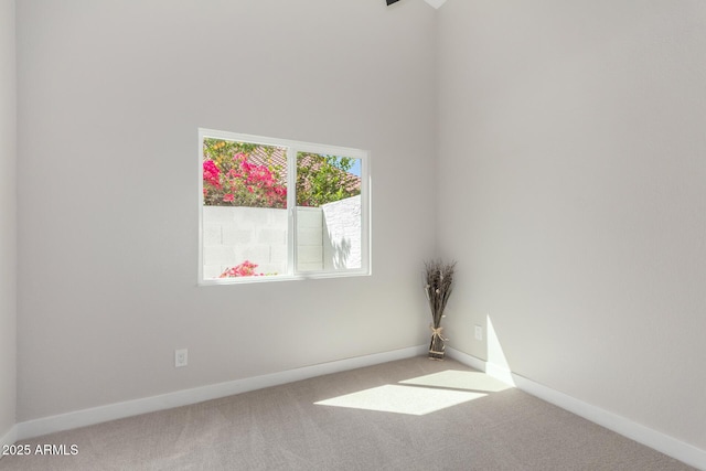carpeted empty room with baseboards