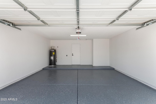 garage featuring a garage door opener, baseboards, and electric water heater