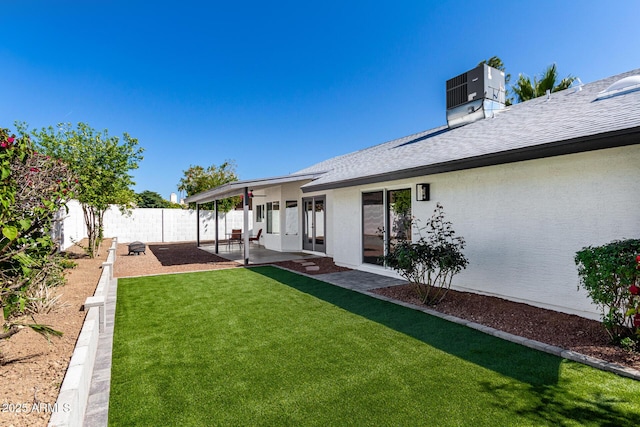 view of yard featuring a patio, central AC, and a fenced backyard