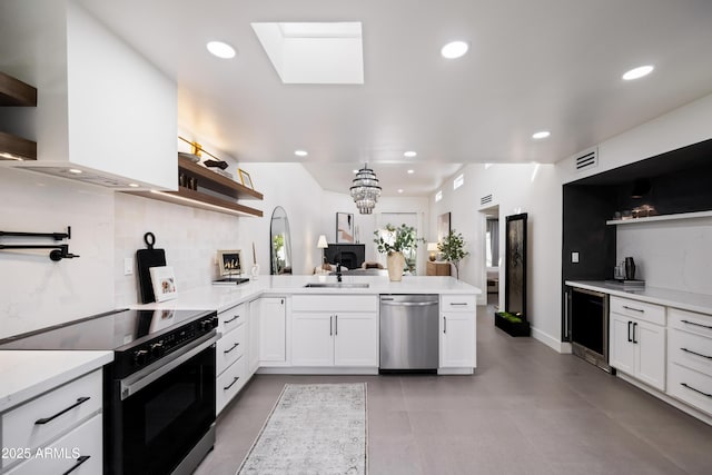 kitchen with visible vents, open shelves, range with electric stovetop, a peninsula, and stainless steel dishwasher