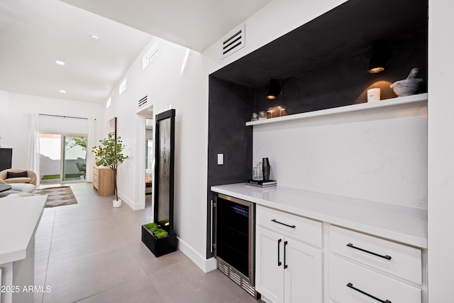 kitchen with visible vents, recessed lighting, wine cooler, white cabinets, and light countertops