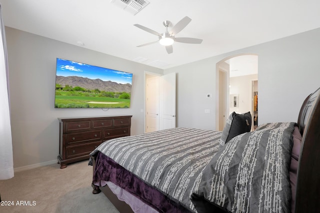 15072 W Mckinley St, Goodyear, AZ 85338 - bedroom with light carpet, baseboards, visible vents, arched walkways, and ceiling fan
