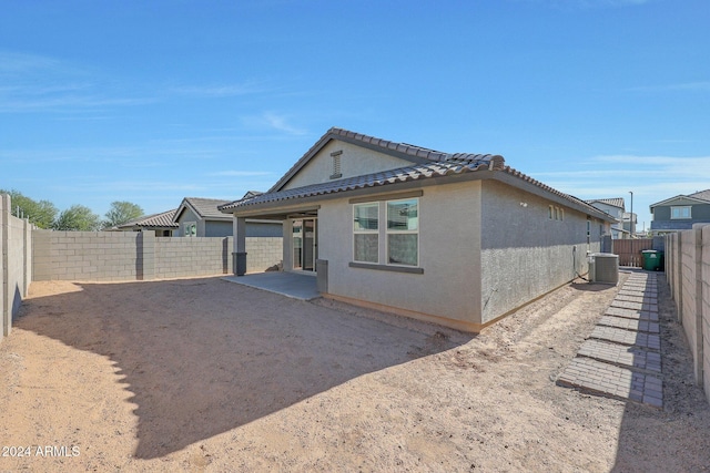 15072 W Mckinley St, Goodyear, AZ 85338 - view of property exterior with stucco siding, a patio, a fenced backyard, a tiled roof, and central AC
