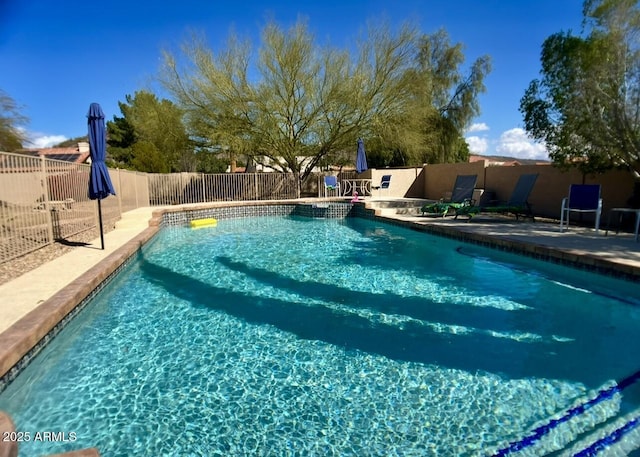 view of swimming pool featuring a patio area, a fenced in pool, and a fenced backyard