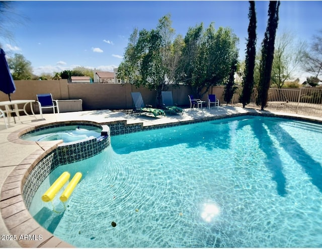 view of swimming pool with a patio area, a fenced backyard, and a pool with connected hot tub