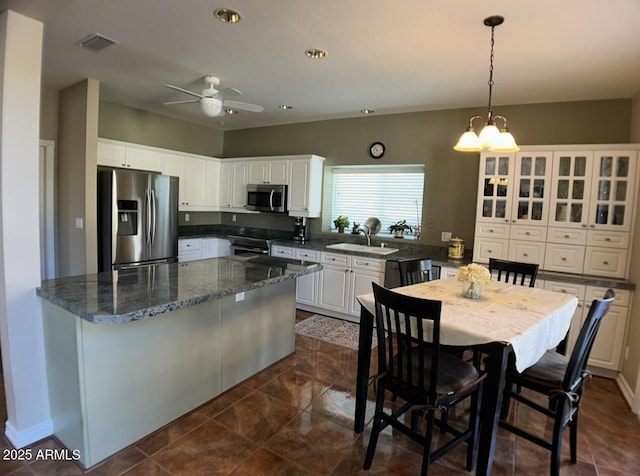 kitchen featuring a sink, white cabinets, visible vents, and stainless steel appliances