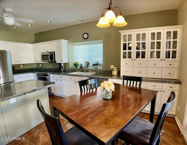 dining space featuring recessed lighting and ceiling fan with notable chandelier