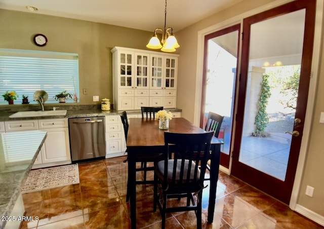 dining space with a chandelier and baseboards