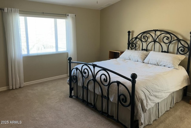 bedroom featuring light colored carpet and baseboards