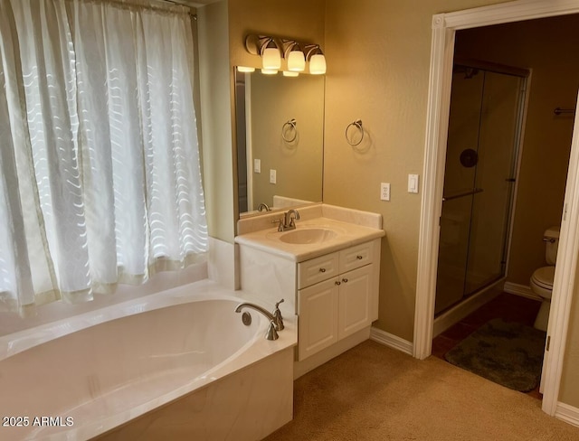 bathroom featuring vanity, a bath, baseboards, a stall shower, and toilet