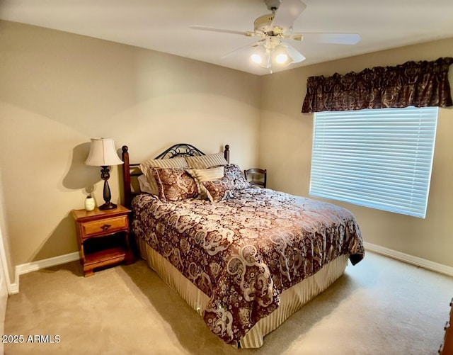 carpeted bedroom with a ceiling fan and baseboards