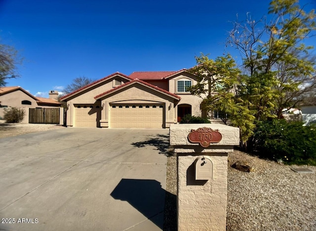 view of front of home with a tiled roof, a garage, concrete driveway, and stucco siding