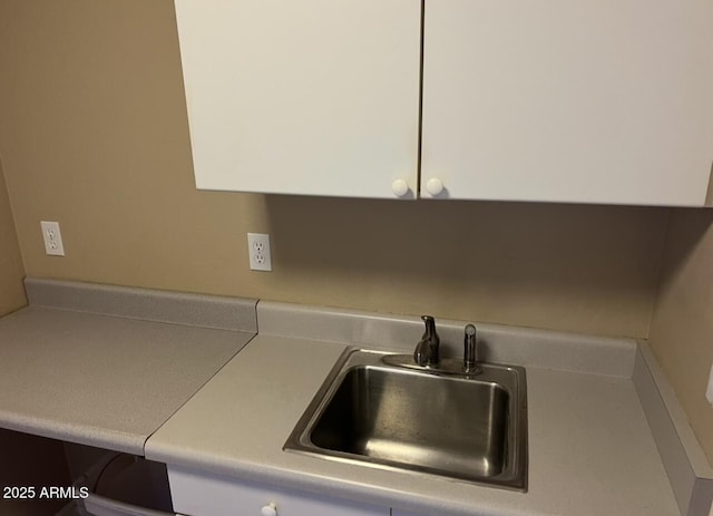 interior details with light countertops and a sink