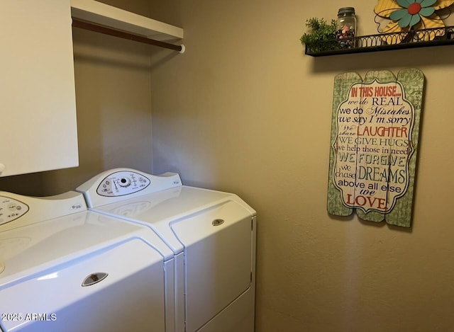 washroom featuring cabinet space and washing machine and dryer