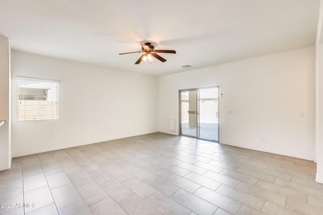 empty room featuring visible vents and a ceiling fan