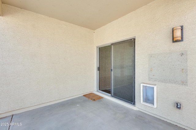 doorway to property with a patio and stucco siding