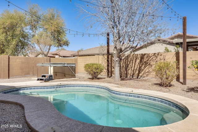 view of swimming pool with a swimming pool and a fenced backyard