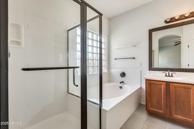 bathroom with a garden tub, a shower stall, vanity, and tile patterned floors