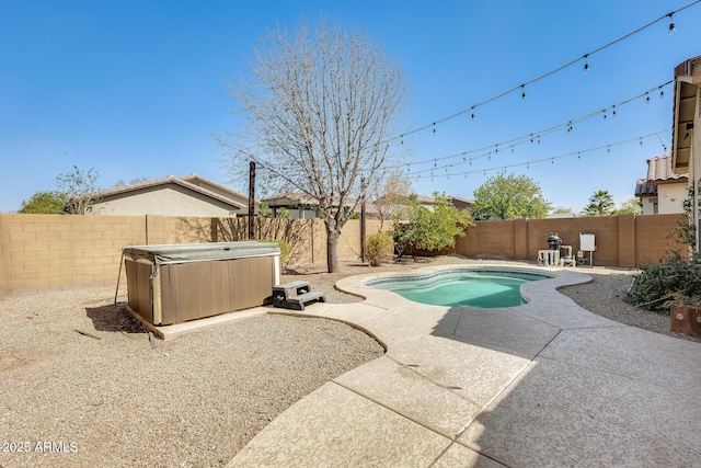 view of pool featuring a hot tub, a fenced in pool, a patio area, and a fenced backyard