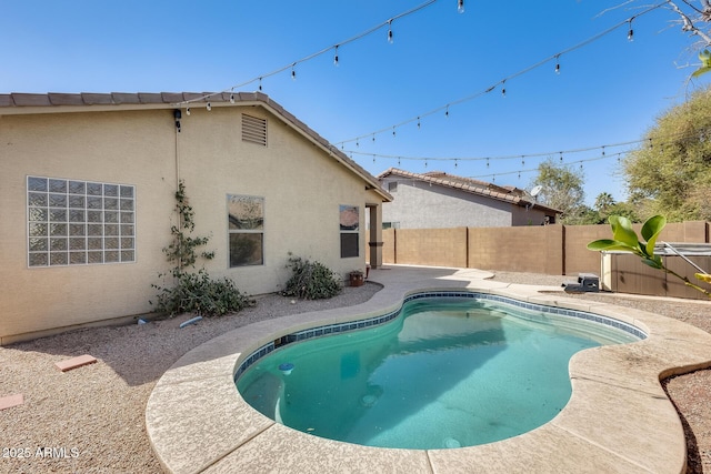 view of swimming pool featuring a fenced in pool, a fenced backyard, and a patio